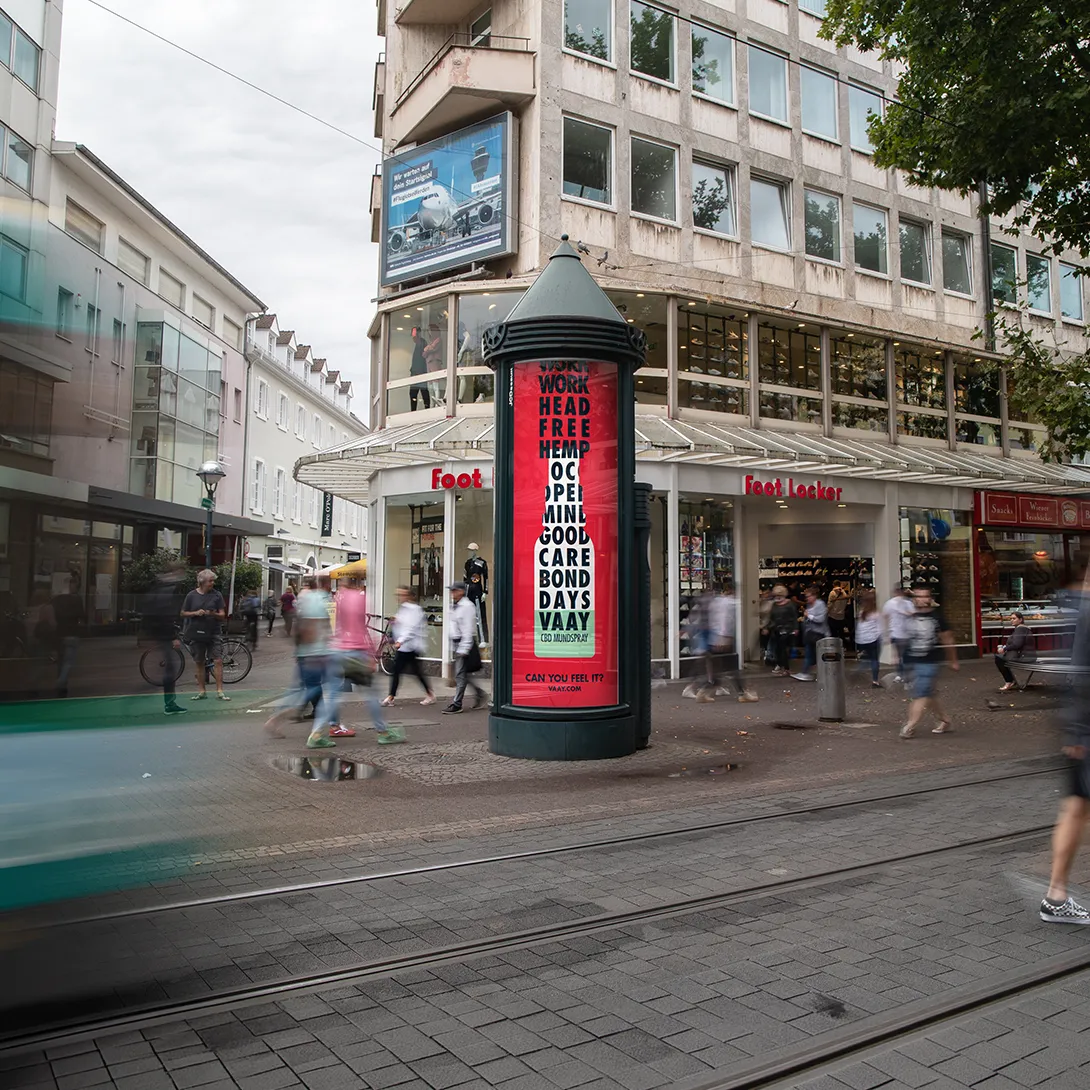 City Light Säule mit Außenwerbung einer CBD-Marke in der Innenstadt von Karlsruhe.