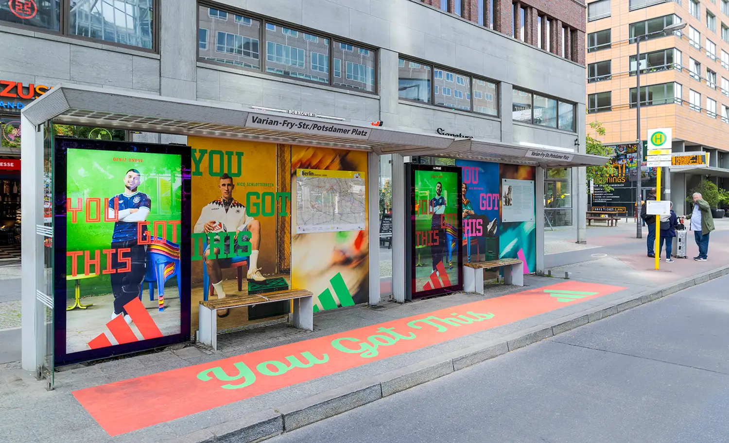 Adidas bus stop ads feature athletes and "YOU GOT THIS" slogan on panels and pavement.