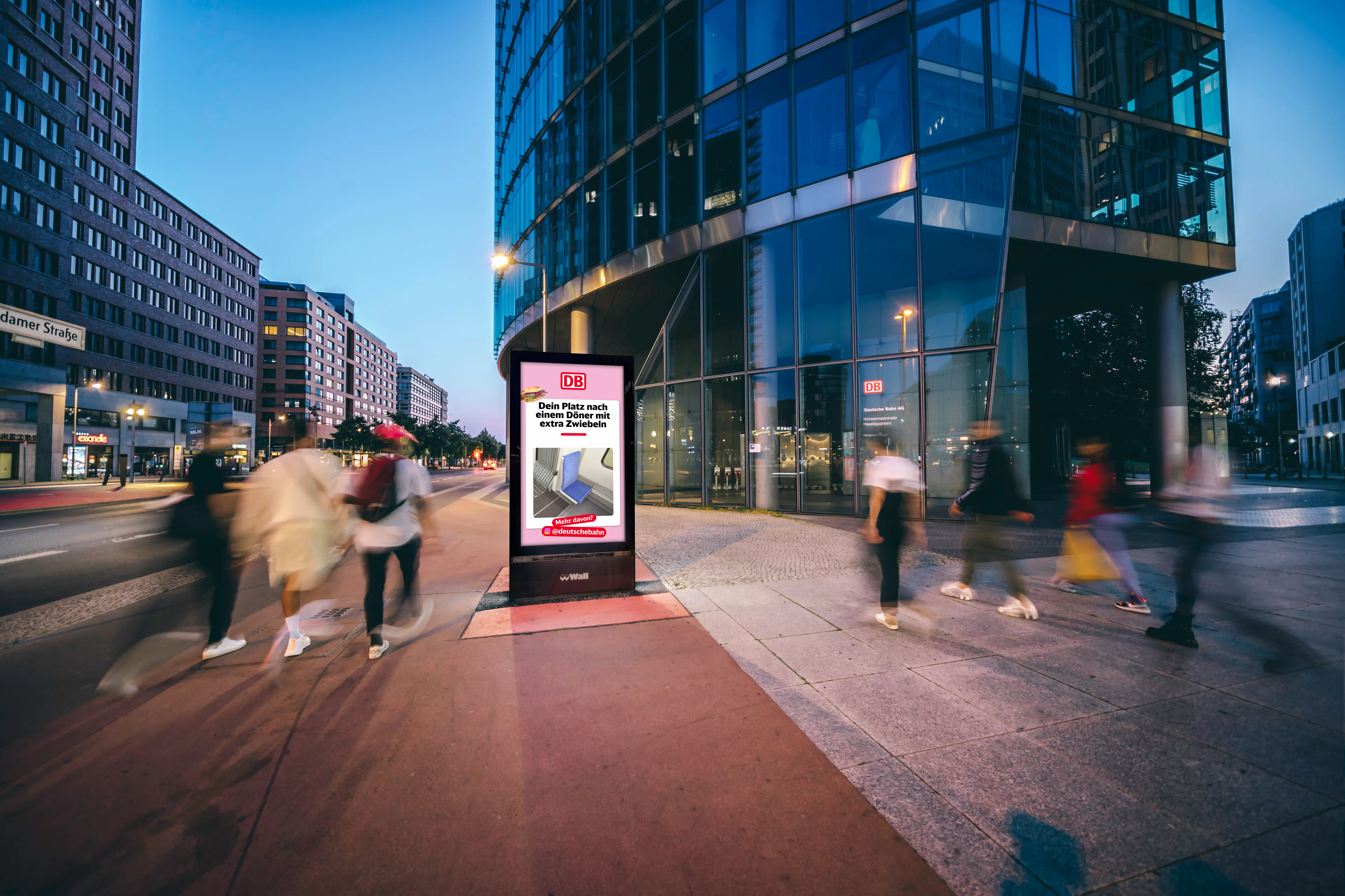 Digital advertising screen displays 'WIN YOUR OWN SNEAKER' on a bustling city sidewalk at dusk.