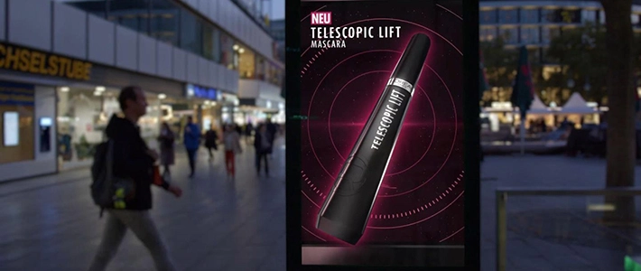 Digital City Light Poster einer Kosmetikwerbung in einer urbanen Umgebung in Berlin bei Abenddämmerung.